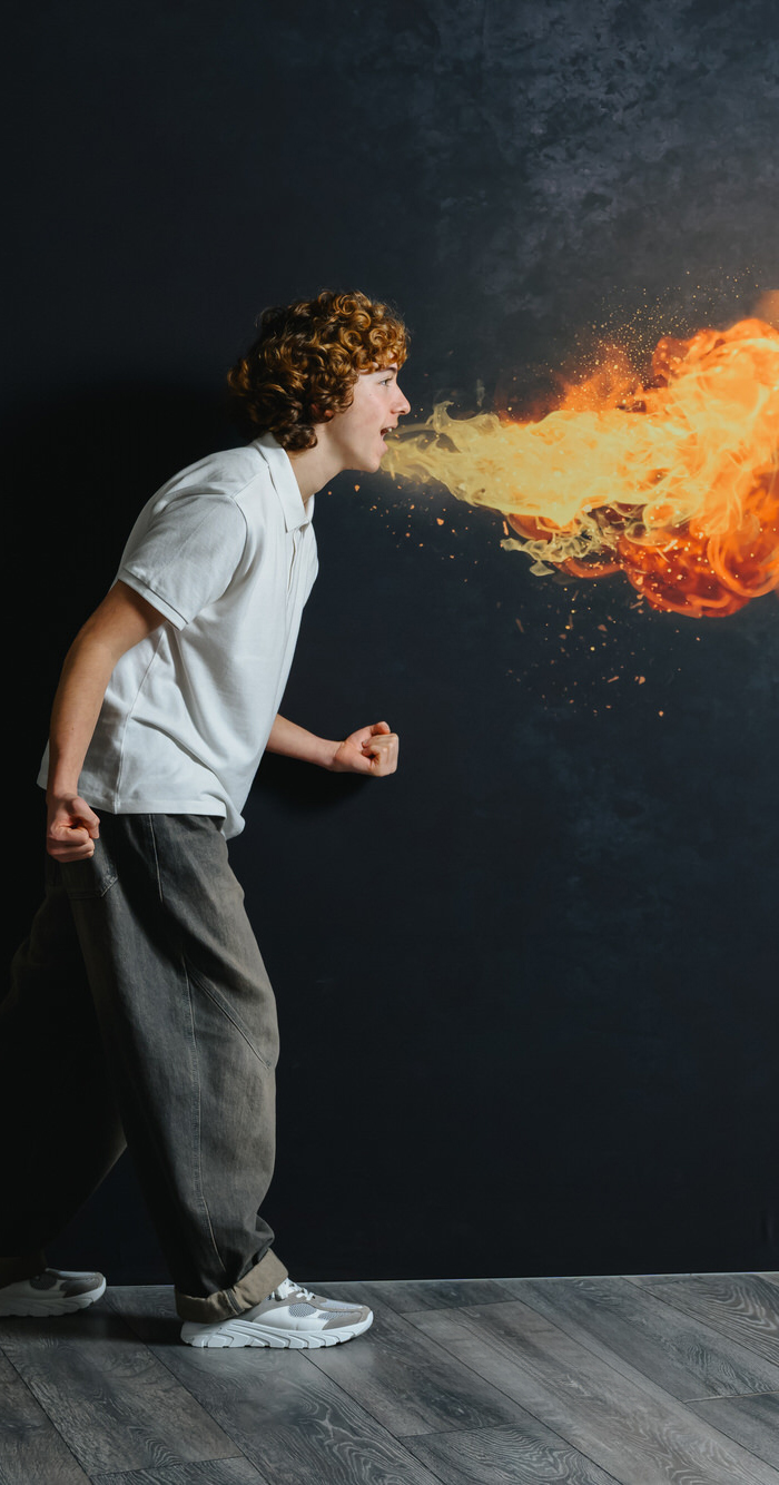 Boy wearing white polo shirt posing with creative fire effect for GIGA kids shoes campaign.